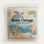 Coastal Harmony laundry basket packed flat in a Rosie Cottage branded bag